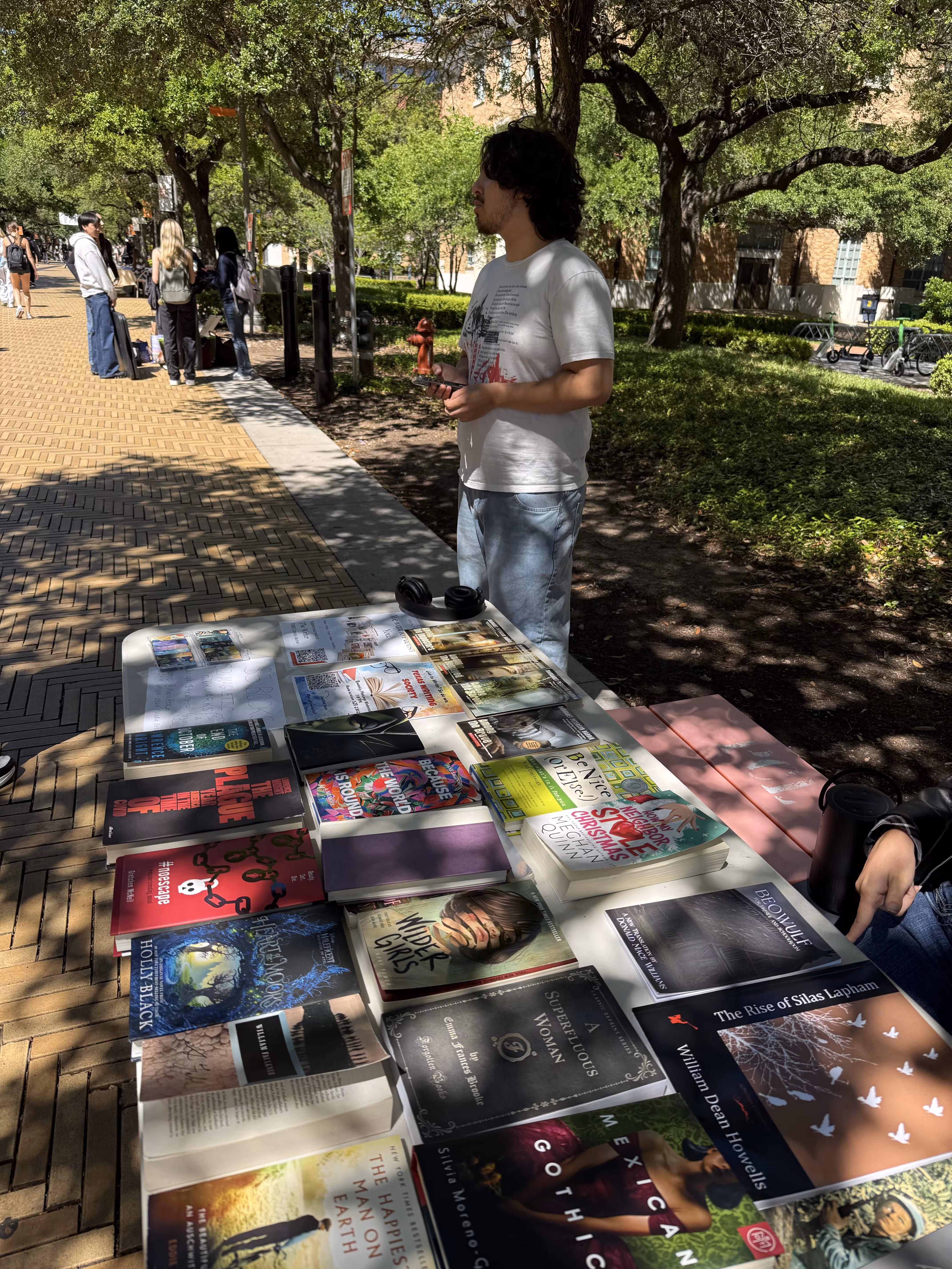 Members browsing books at a TXWS tabling event
